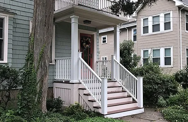 A house with steps leading to the front door.